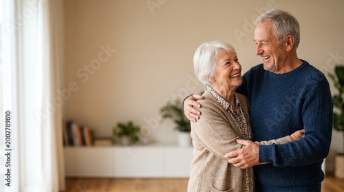 Elderly couple embracing and smiling lovingly, celebrating their enduring relationship and companionship at home