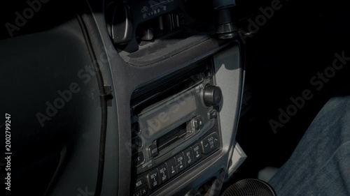 Inserting a CD into the Factory-Installed Head Unit Mounted on the Dashboard of the Retro Car and Starting to Play Music