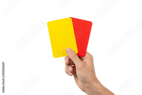 Hand holding a yellow and red card