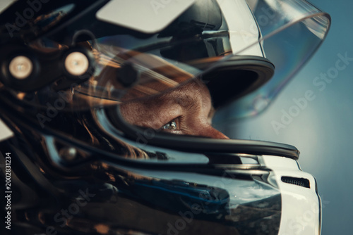Racing Driver in Carbon Fiber Helmet Sitting Inside Race Car before the start