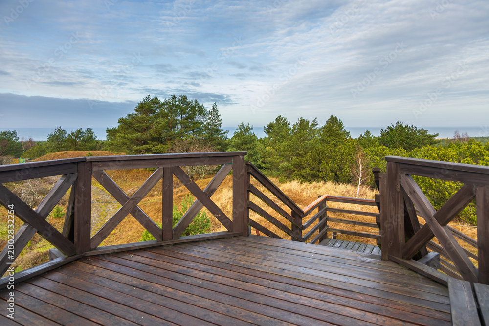 Fototapeta premium Wooden observation deck overlooking Czolpino dunes Baltic Sea, Poland.