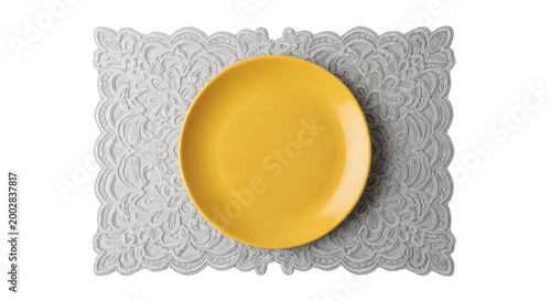 Yellow plate on a gray lace placemat isolated on transparent background