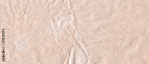 Foto Crumpled light brown kraft paper texture background with center fold crease for