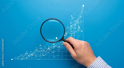 Hand with magnifying glass over an ascending line graph with interconnected dots on blue