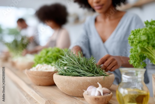Culinary team preparing fresh herbs and ingredients on a wooden counter for food preparation background and organic recipe design