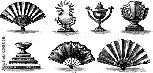 Antique hand fan and decorative trophies arranged on studio background