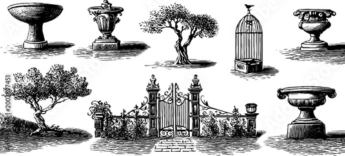 Antique garden ornaments displayed beside ornate iron gate
