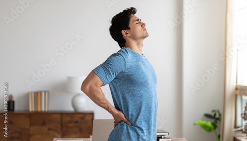 Man with back pain at desk.