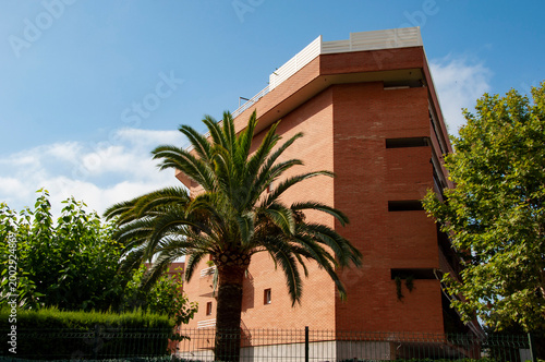 Architectural brick building. Residential touristic district. Hotel in Spain, Salou. Summer vacation. Residential architectural district. Modern building in city. Residential building architecture