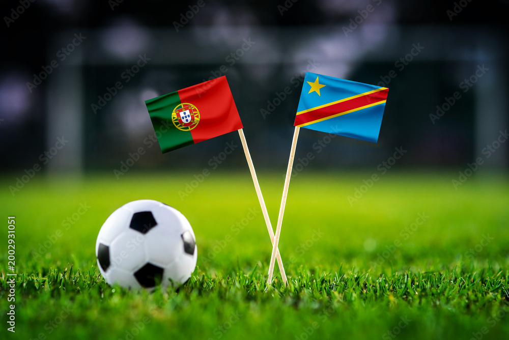 Fototapeta premium Portugal vs DR Congo, national flags before world championship Group K group stage match, football on green pitch with goal in the background, Houston, USA, June 17, 2026