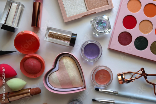 Various colorful cosmetic products on white background. Flat lay.