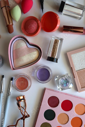 Various colorful cosmetic products on white background. Flat lay.