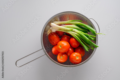 Fresh Red Tomatoes and Spring Onion on white background.