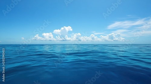 Tranquil Ocean Scene Blue Water and White Clouds Under Bright Sky