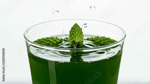 Refreshing Mint Drink Being Poured into a Glass with Fresh Leaves