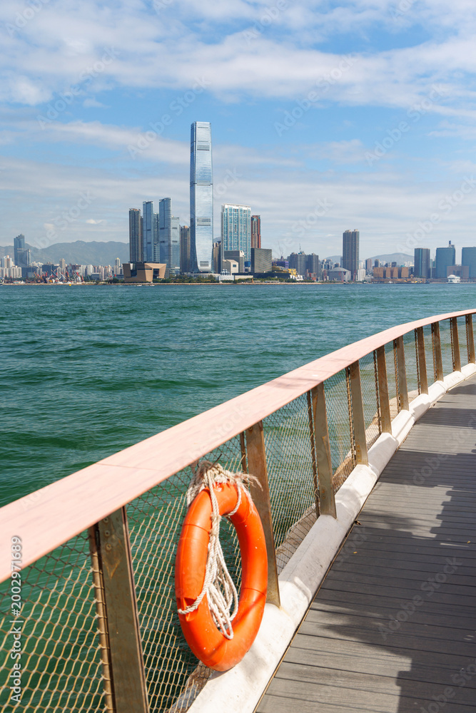 Fototapeta premium Hong Kong skyscraper panorama on a sunny day with water and boats