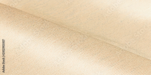 Soft fabric gracefully drapes, the texture highlighting the subtle play of light and shadow, evoking a sense of calm and tactile elegance.