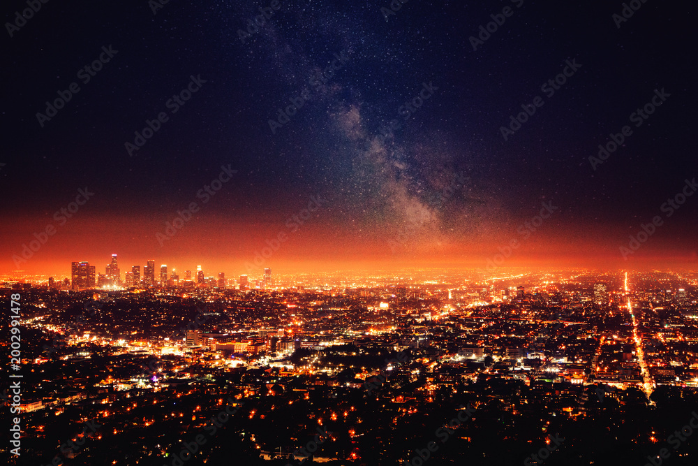 Fototapeta premium Milky way glowing over los angeles city lights at night