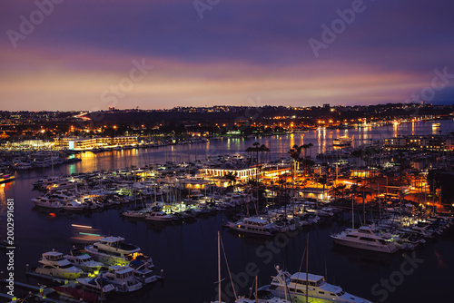 Marina del rey harbor at dusk with city lights reflecting