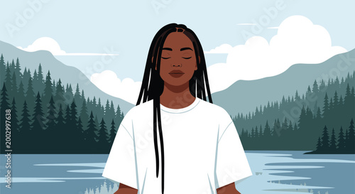 Calm Black woman with long braids practices meditation with eyes closed in front of a serene mountain and lake view.