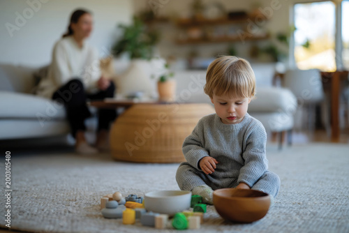 A young child is playing with colorful wooden blocks and a bowl in a cozy room, showcasing a nurturing environment that encourages imaginative play and creativity.