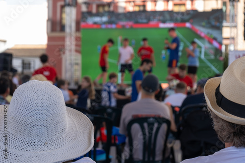 Quadro em tela Audience watching football presentation on big screen at outdoor fan gathering i