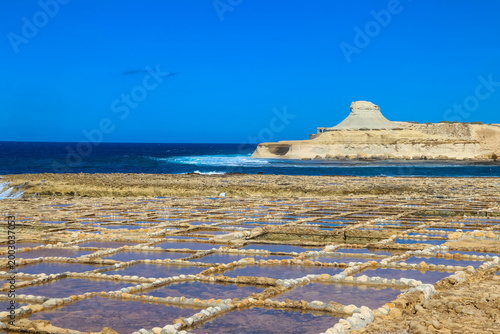 Beautiful view of white hillrock Qolla l-Bajda, also known as Xwejni Rock and Xwejni Salt Pans near Marsalforn on the island of Gozo, Malta