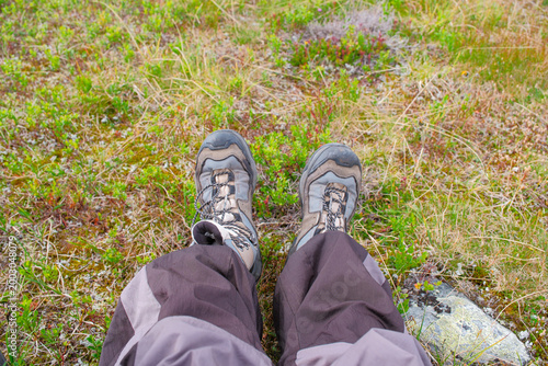 Close up of hiking boots on rocky Kungsleden trail in Laponia Sweden during summer trekking