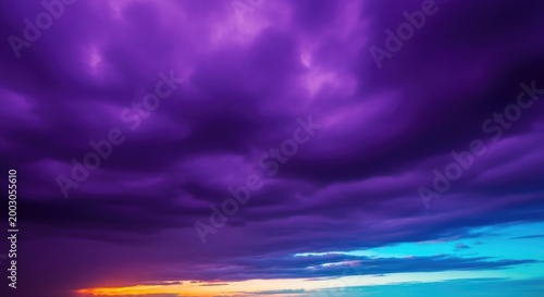 Vibrant purple clouds fill the sky during a dramatic sunset with orange and blue hues