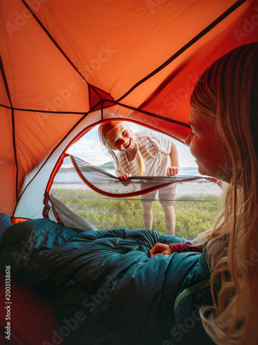 Family camping vacations - child peeking into tent to wake her mother, travel lifestyle outdoor kid and parent enjoying summer holidays adventure trip happy candid emotions bonding moments