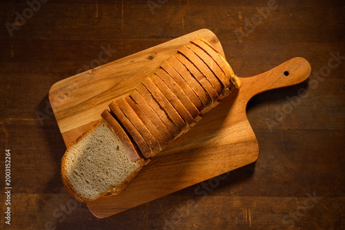 Whole wheat  bread on wooden background
