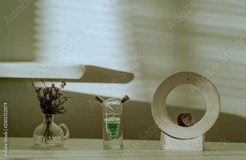 Minimalist still life with decorative objects and warm sunlight shadows, modern home interior design