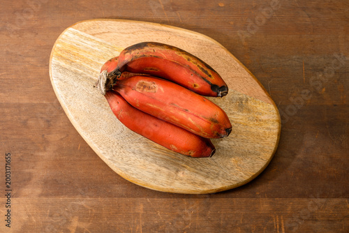 Bunch of Red Bananas on wooden background