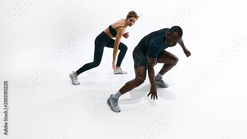Konstfotografi Fit couple performing beep test shuttle sprint exercise for endurance assessment