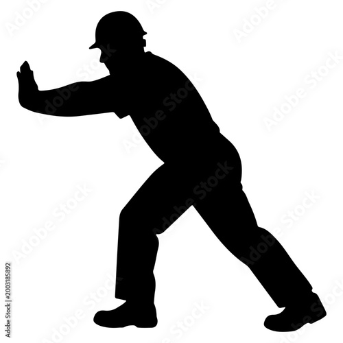 Silhouette of a construction worker pushing a wall.