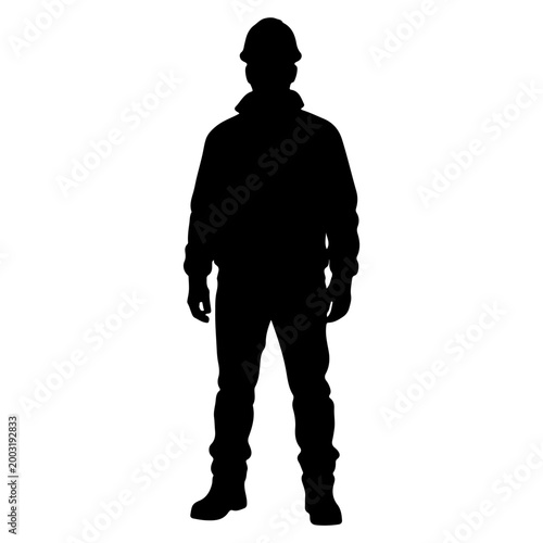 Silhouette of a construction worker standing confidently.