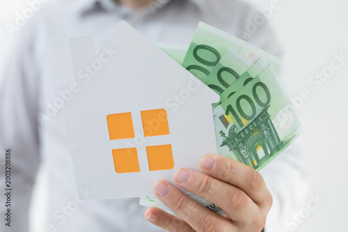 Person holding house symbol...