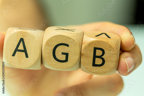 Hand holding three wooden b...