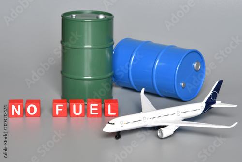Miniature oil barrels with a plane and the words 