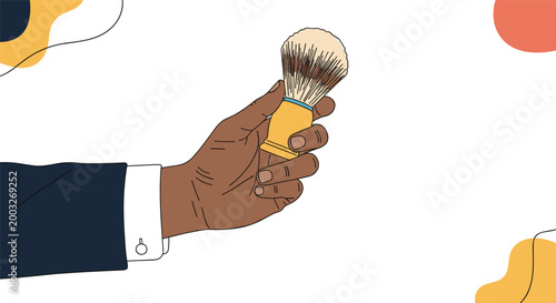 Dark skinned hand in a suit sleeve holding a wooden shaving brush with natural bristles on an abstract background.