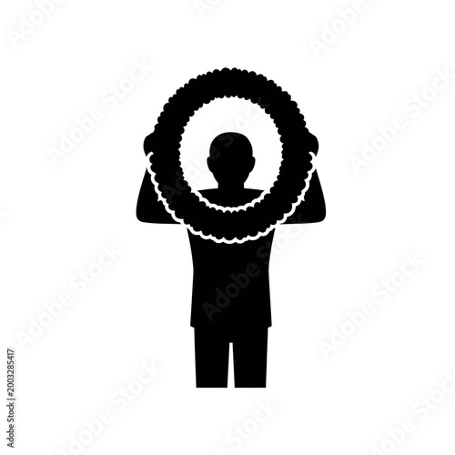 Silhouette of a person holding a wreath.