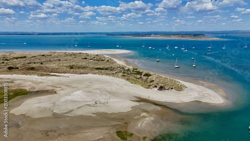 фотографія Aerial view from drone of East Head sand dune spit and coastal salt marsh at Wes