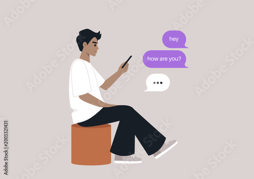 A young individual is sitting comfortably on a pouf, deeply engaged in a smartphone conversation, The casual setting invites a sense of calm and connection with friends.