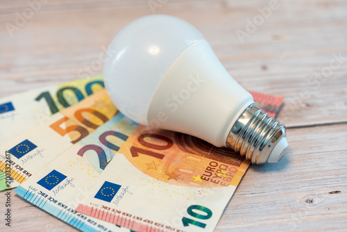 LED light bulb with euro money concept for energy cost and efficiency saving