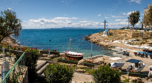 Inlet with small, traditional, Greek chapel on the shore of Piraeus port, Athens, Greece