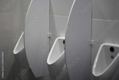 urinals in a men's public restroom
