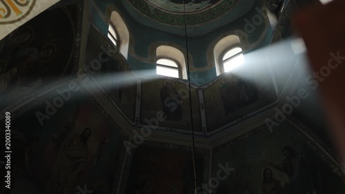 Serene interior with glowing frescoes and luminous dust particles