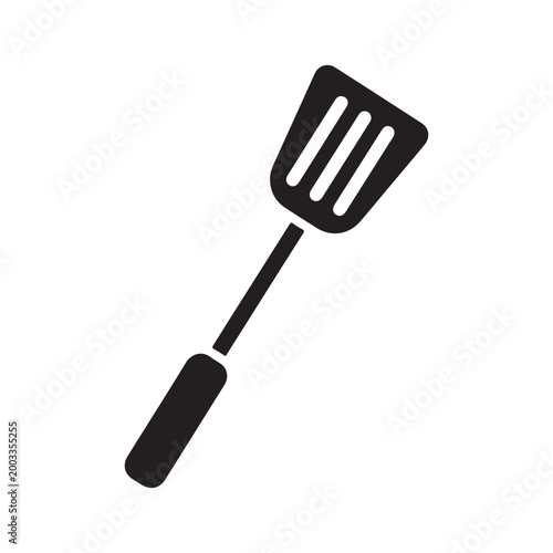 A simple black and white illustration of a kitchen spatula a common cooking utensil
