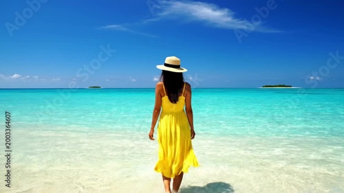 Woman Walking on Sandy Beach Shore.
