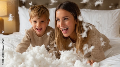 Joyful Moment with Pillow Fight: A tender scene unfolds as a mother and child revel in a playful pillow fight on a bed, capturing a moment of pure joy and familial bliss.